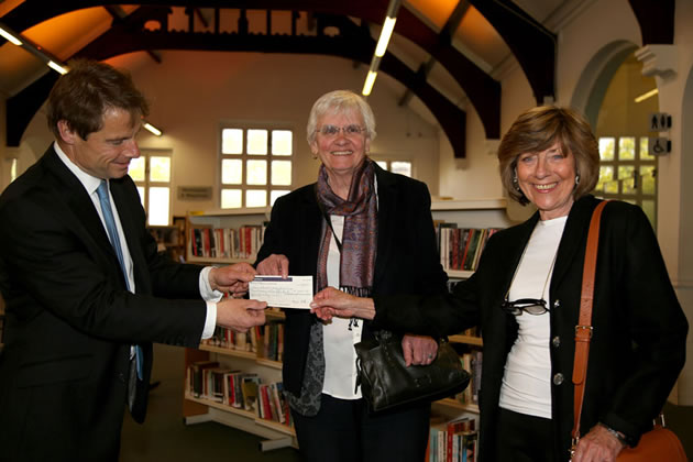 Cllr Jonathan Cook presents the cheque to Andree Rushton and Jean Stanley from the Friends of Putney Library