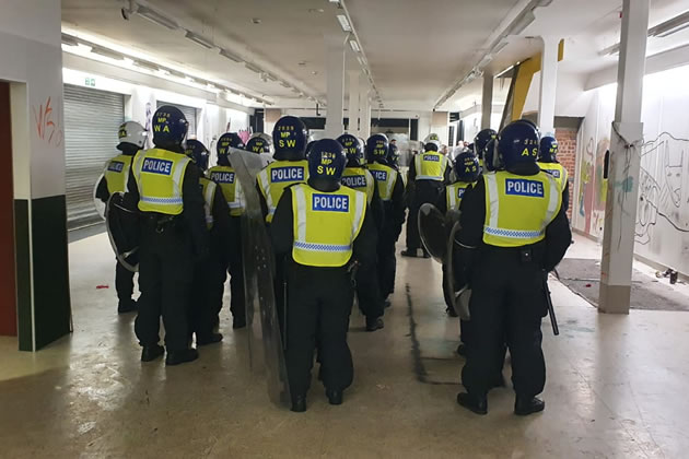 Police officers in riot gear assemble to deal with incident 