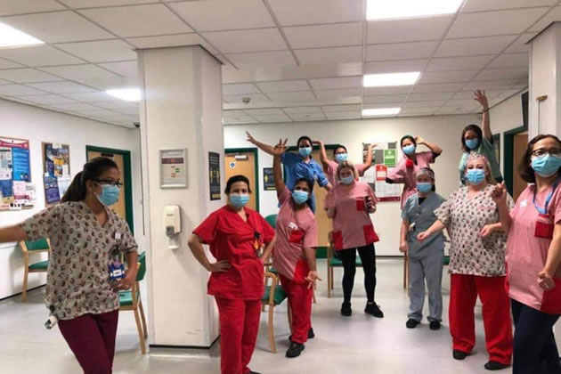 Health workers show off their scrubs supplied by the Scrubbery