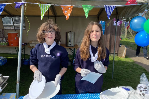 Young volunteers serving up burgers and hot dogs at a previous Boat Race event